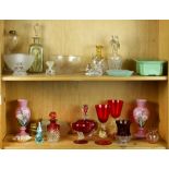 Two shelves of cut glass and colored glass tablewares