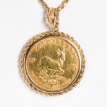A gold coin and fourteen karat gold pendant necklace