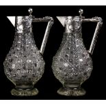 A pair of German .830 silver mounted claret jugs