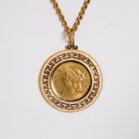 A gold coin and gold pendant necklace