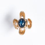 A synthetic star sapphire and gold plated ring