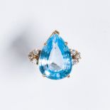 A blue topaz, diamond and fourteen karat gold ring