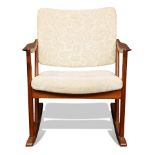 A Danish Modern rocking chair, having wide sloped arms, above cream upholstery, 29.5"h