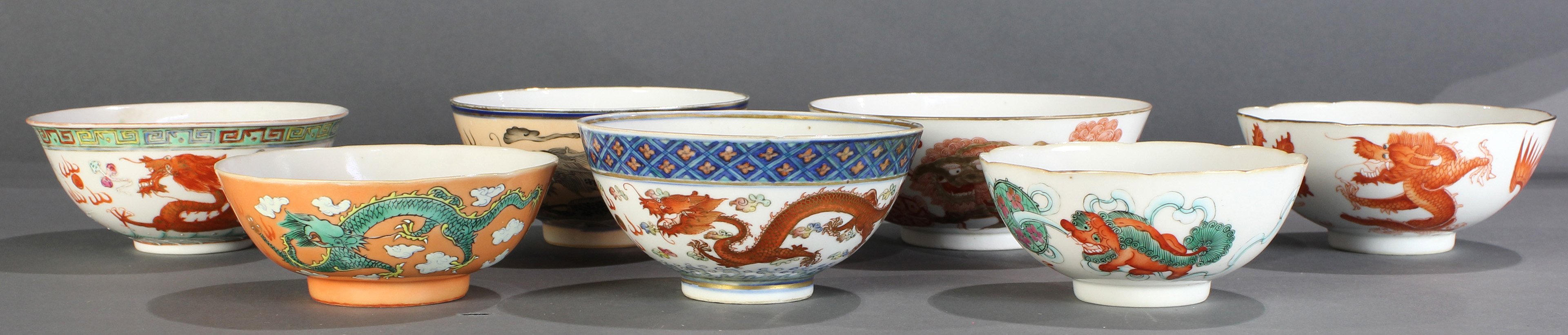 (Lot of 7) A Group of Famille Rose 'Dragon and Phoenix' and 'Lion' Bowls