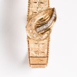 A fourteen karat gold and diamond conealed wristwatch bracelet, Hilton