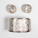 A sterling silver and fourteen karat gold cuff bracelet and earring suite