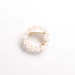 A pearl and fourteen karat gold brooch