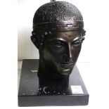 A Classical style figural sculpture depicting the face of an Olympian