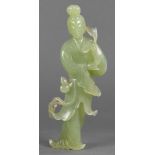 Chinese serpentine carved figure of Bodhissatva hewn from a pale green stone specimen