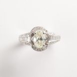 A yellow diamond and fourteen karat white gold ring