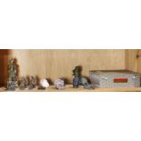 A shelf of Chinese Buddhist stone and bronze items