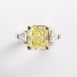 A fancy light yellow diamond, colorless diamond, eighteen karat white gold and platinum ring