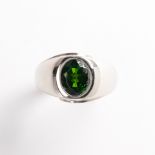 A peridot and fourteen karat white gold ring