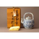 A Blue and White Teapot and Cover with Wooden Base