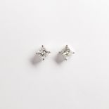 A pair of radiant-cut diamond and fourteen karat white gold stud earrings