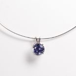 A purple cubic zirconia and fourteen karat white gold pendant necklace