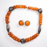 An amber and silver bead necklace and pair of earclips