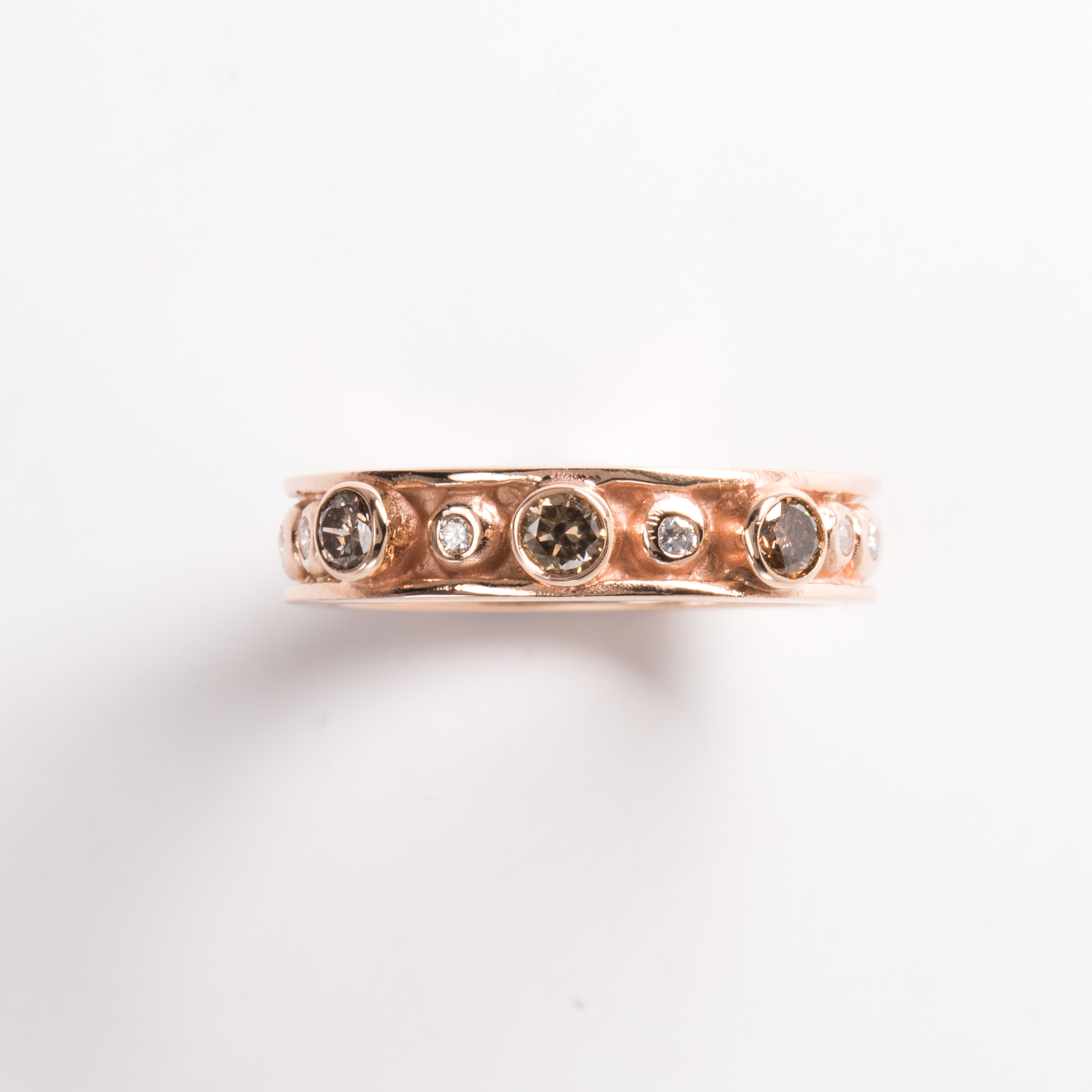 A cognac and champagne diamond fourteen karat rose gold ring