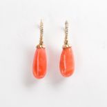 A pair of coral, diamond and fourteen karat gold drop earrings