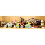 One shelf of ceramic and wood folk art pieces