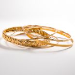 A group of gold bangle bracelets