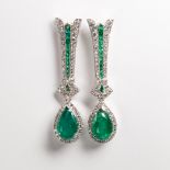 A pair of emerald, diamond and eighteen karat white gold earrings