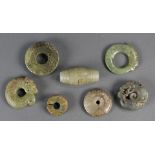 7 Archaistic style green hardstone carvings, mostly bi discs