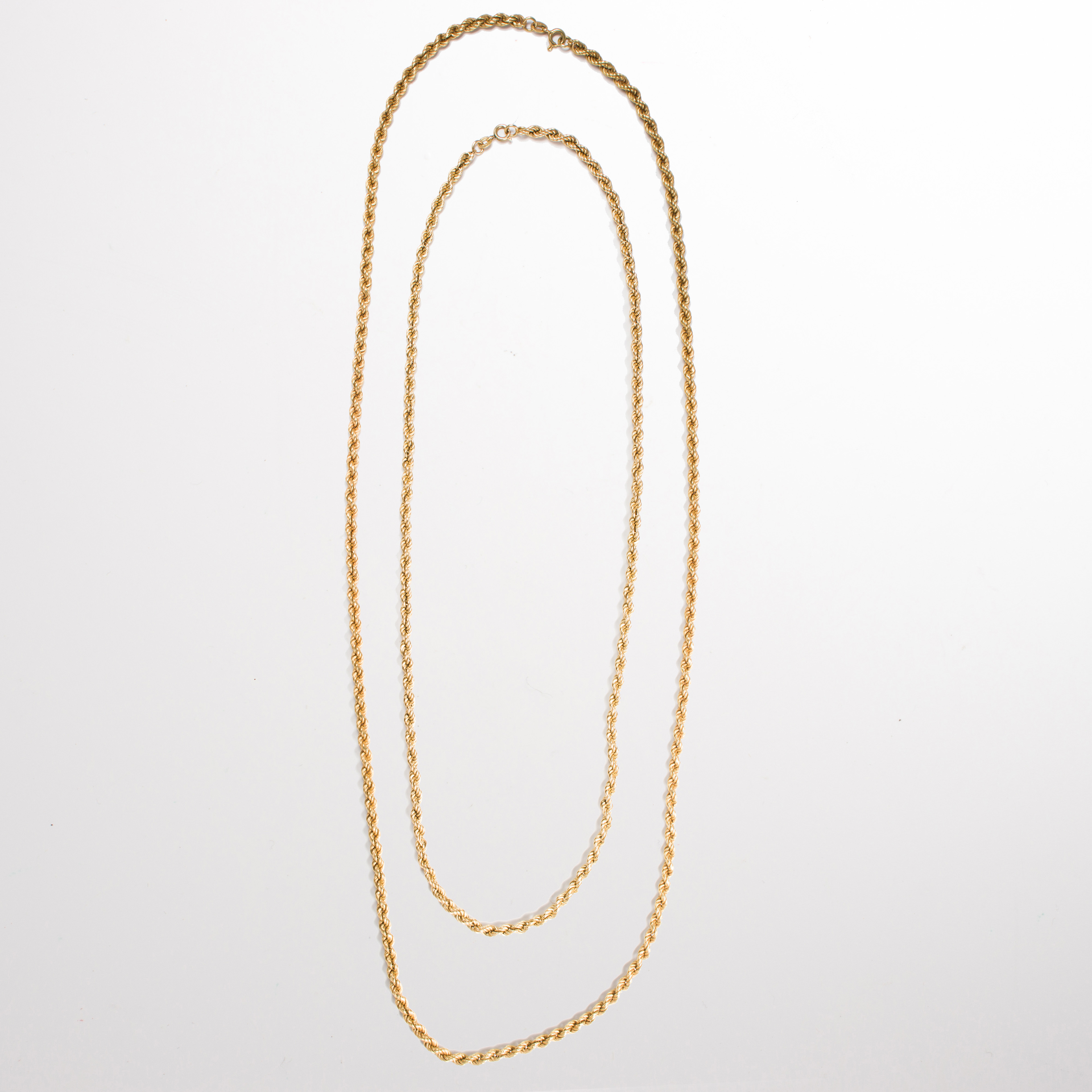 A pair of fourteen karat gold chain necklaces