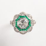 A diamond, emerald and platinum ring