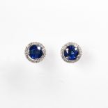 A pair of sapphire, diamond and fourteen karat white gold earrings