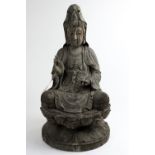 A Chinese weathered wood figure of seated Guanyin