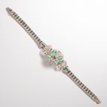 A diamond, emerald and fourteen karat gold strap bracelet