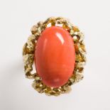 A coral and fourteen karat gold ring