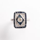 A Late Art Deco diamond, synthetic sapphire and fourteen karat white gold ring