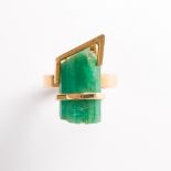 An emerald and eighteen karat gold ring