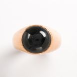 A synthetic black cat's eye sapphire and fourteen karat gold ring