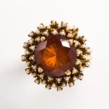 An orange citrine, seed pearl and fourteen karat gold ring