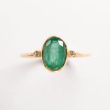 An emerald, diamond and eighteen karat gold ring