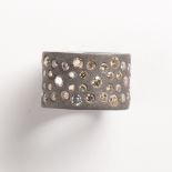 A colored diamond and blackened silver ring