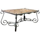 A Wrought iron and distressed wood dining table