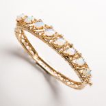 An opal, diamond and fourteen kart gold bangle bracelet