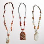 A group of nephrite and orange agate bead necklaces