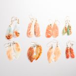 A group of orange agate earrings