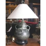 Patinated metal bulbous urn mounted as a lamp