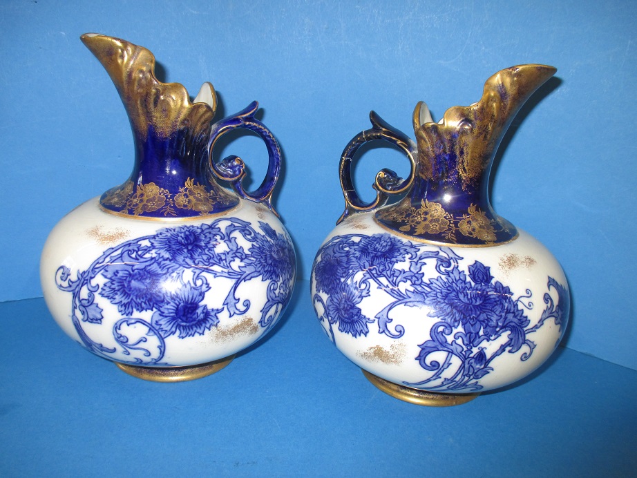 A pair of Macintyre squat ovide jugs decorated with rich blue and gilt floral motif, printed marks