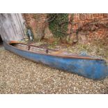 A vintage wooden slat hull and canvas lined canoe