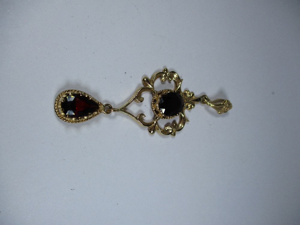 A gold pendant set with garnets with a 9ct fox tail chain, approx weight 10.9g - Image 2 of 7