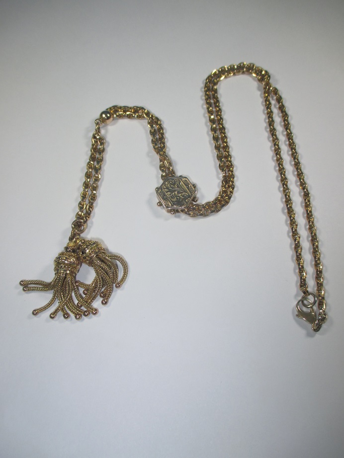 A long yellow metal necklace with tassel ends, approx weight 18.9g