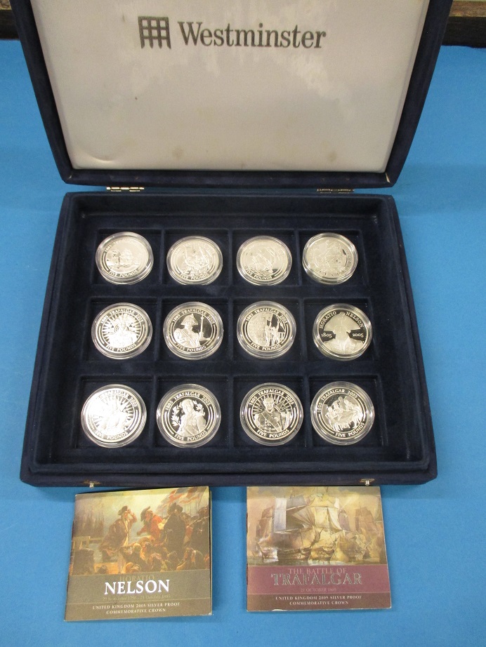A cased set of 12 sterling silver proof 5 pound coins commemorating Nelson