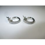 A pair of 18ct white gold and diamond earrings